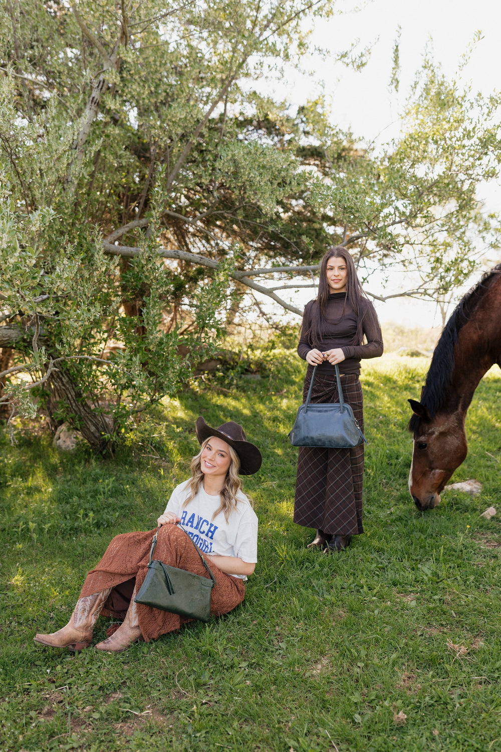 A woman wearing a Joy Susan Eve bag in a fall setting