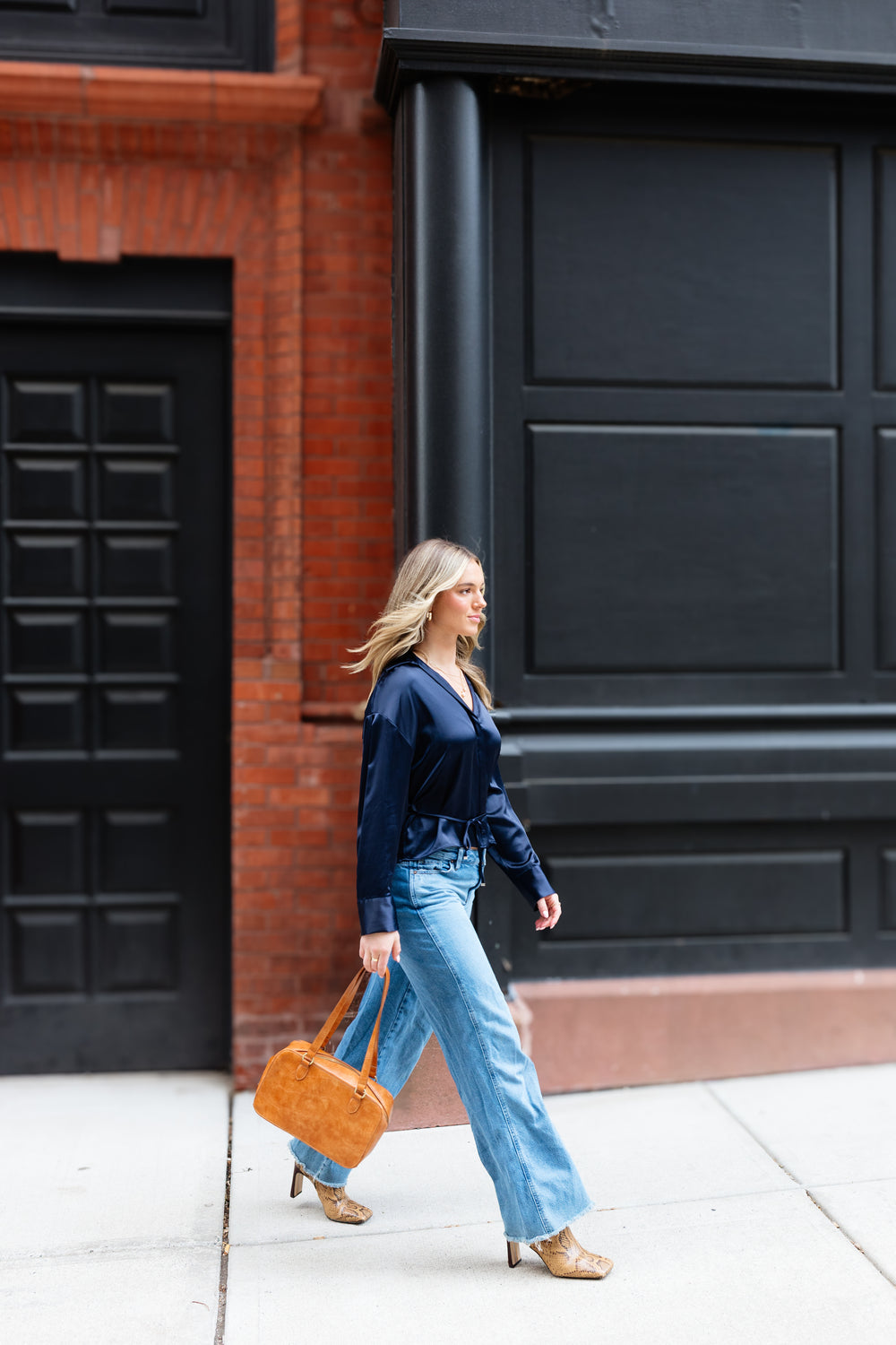 A woman carrying a Joy Susan Jackie bag